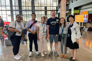 Nick Curry stands next to other Amazon employees at the office.