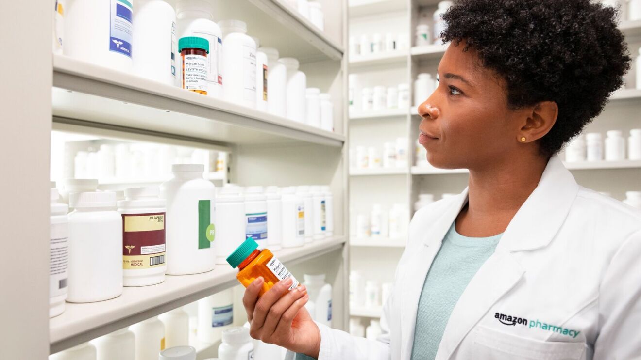 Female pharmacist checking medicine inventory