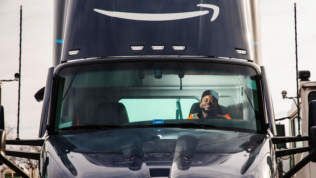 portraits and environmental photos of abel tuyisenge, a transportation operations management associate at amazon, as he drives and inspects trucks