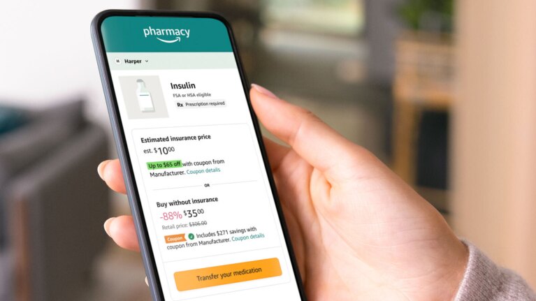 An image of a hand holding a phone that shows the Amazon Pharmacy prescription checkout site. 