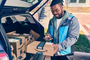 Amazon delivery driver delivers a package to a customer.