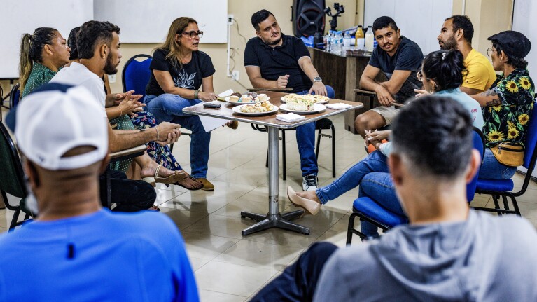 Group of people seated around a table discussing