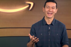 An Amazon senior manager talks about interview tips with an Amazon logo behind him.