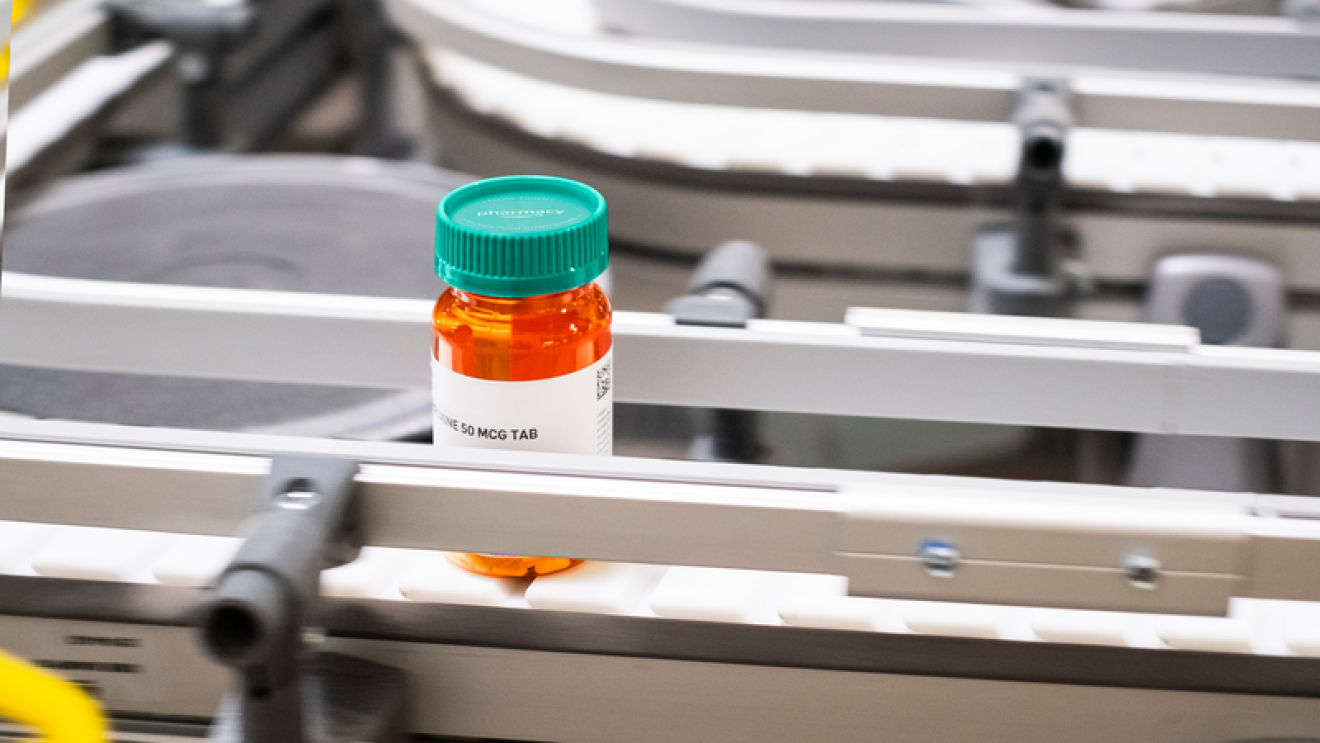 An Amazon Pharmacy prescription bottle in a fulfillment center.