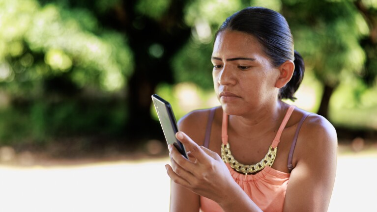 Lady sitting and using a phone