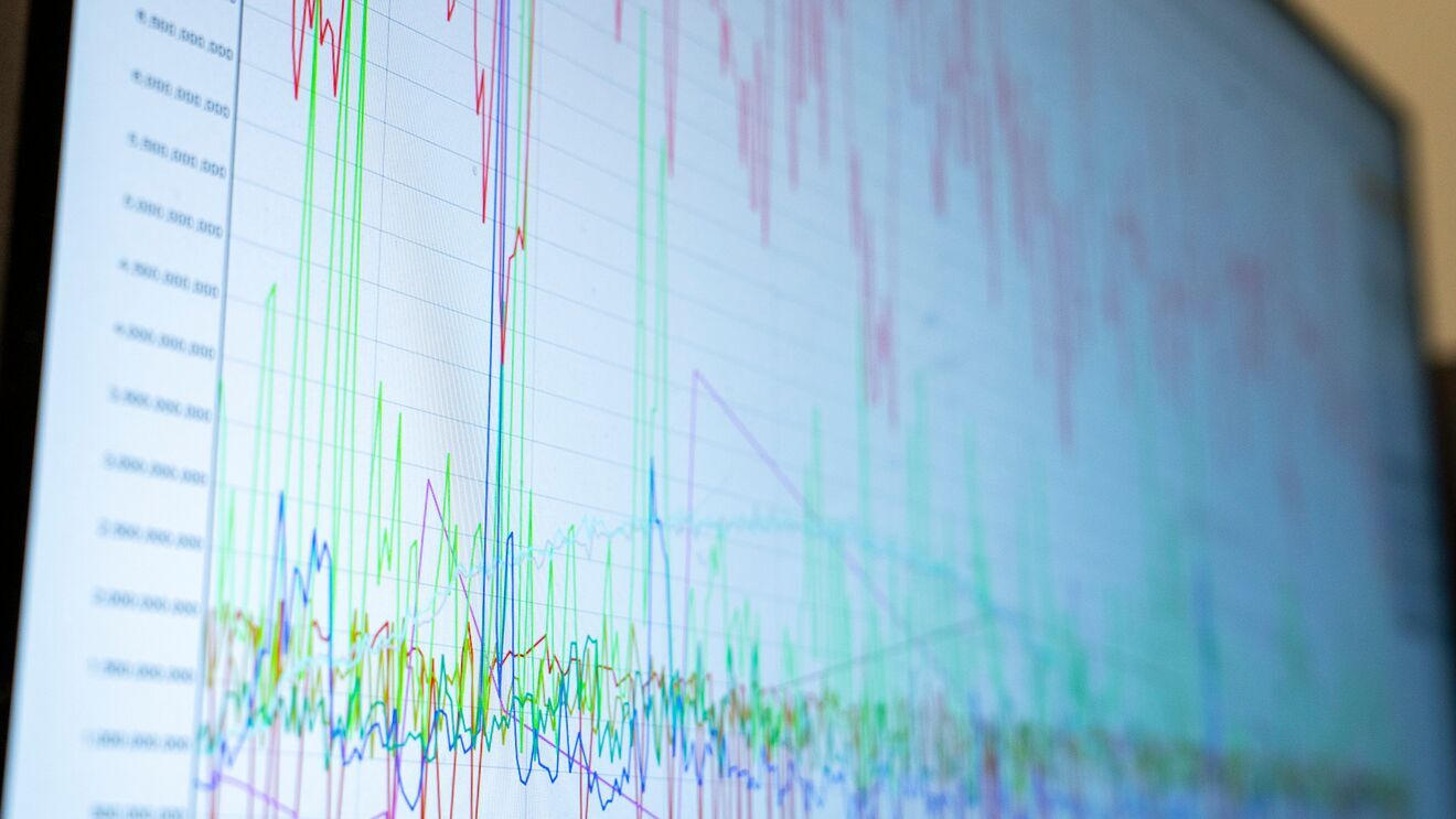 A photo of a screen monitor that displays internet traffic spikes.